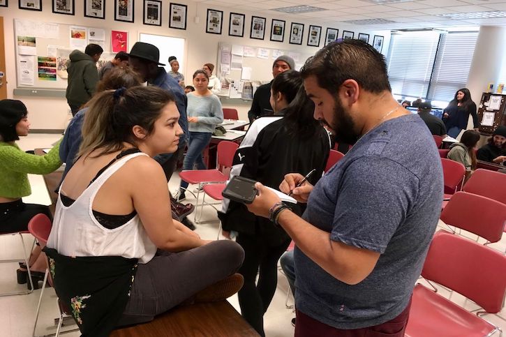 students in classroom interviewing one another